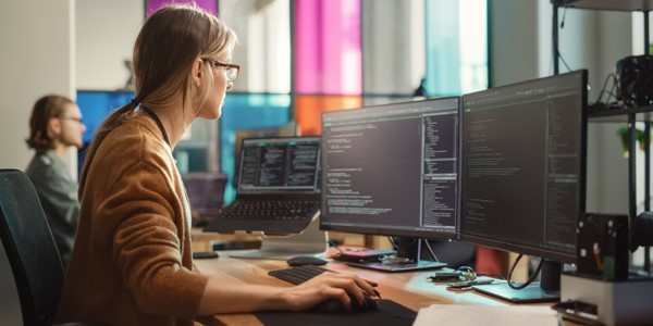 Woman looking at computer screens