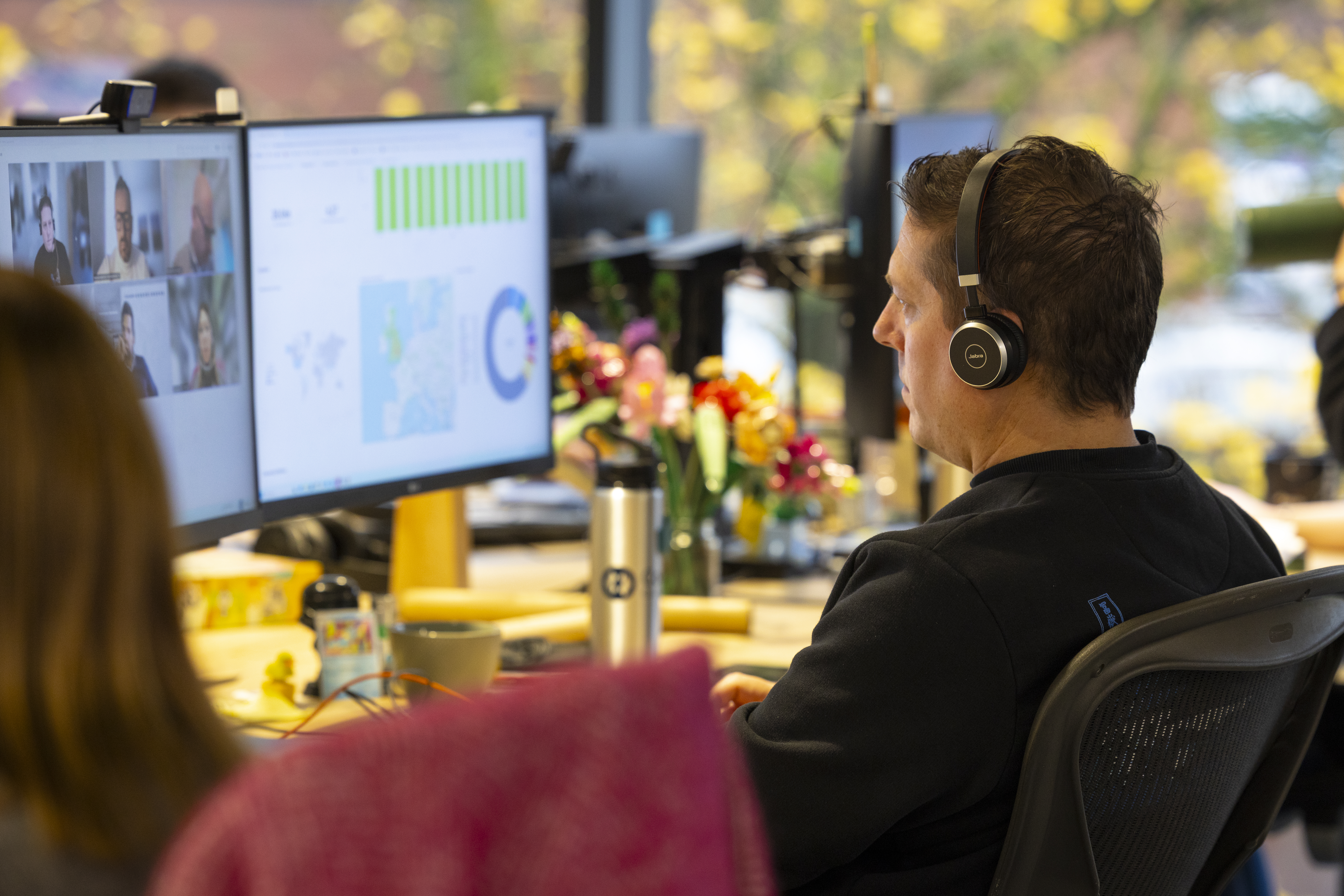A software developer at their laptops within a modern office