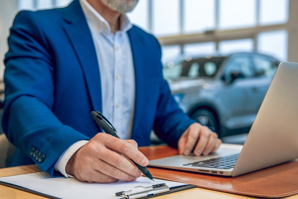 Car dealer completing admin processes