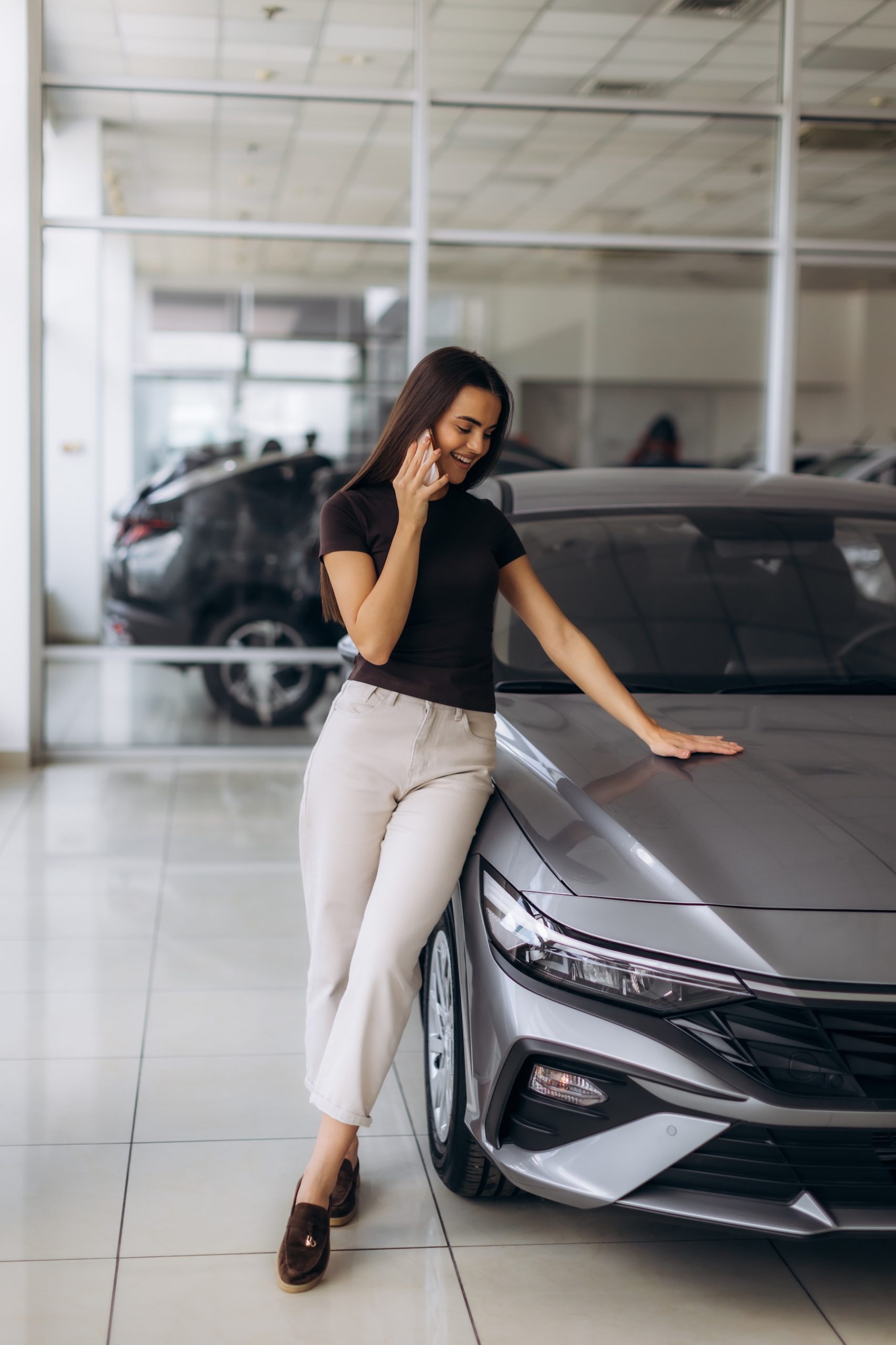 Customer on the phone while buying a car